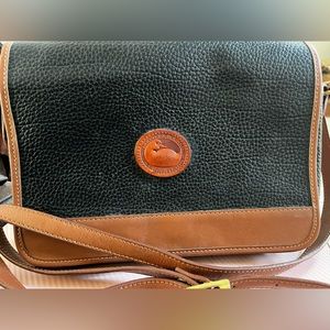 Dooney & Bourke black leather purse, snap closure, brown leather trim